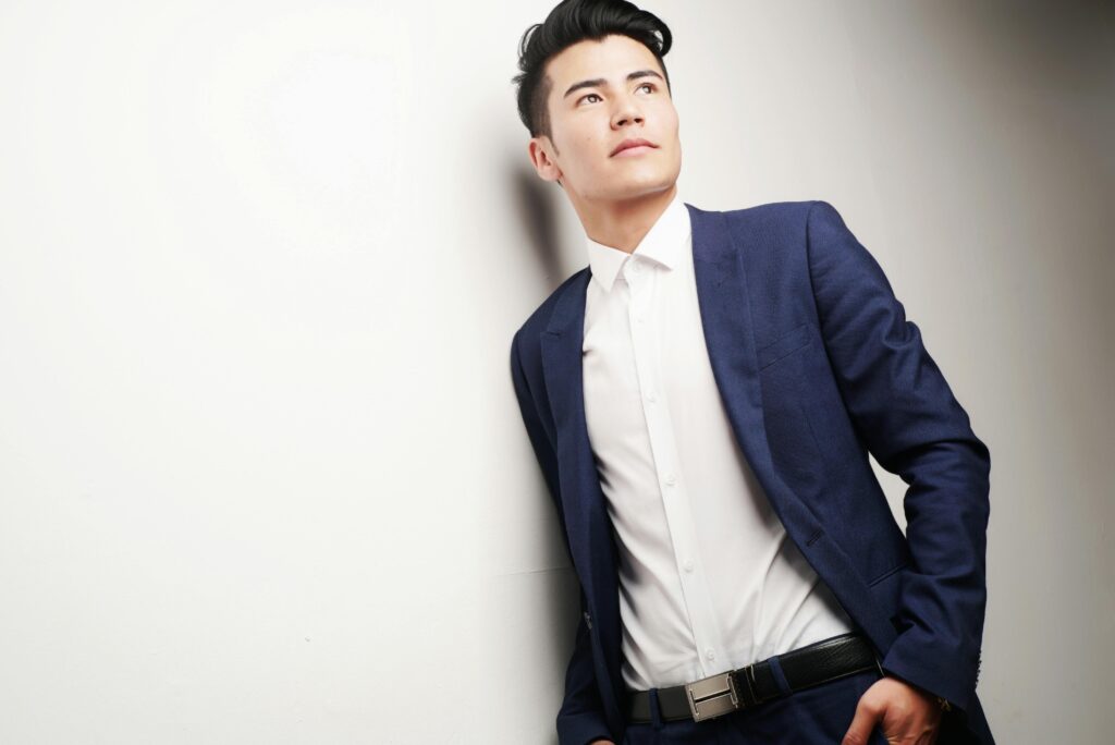 Elegant businessman in a blue suit looking thoughtful, ideal for corporate themes.